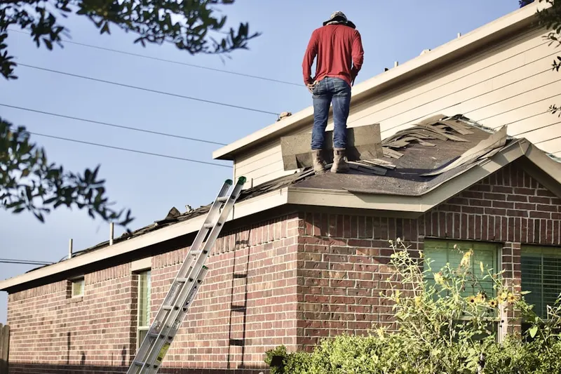 Professional roofer working on a residential roof in North Easton